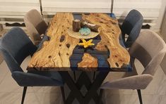 a wooden table with blue chairs around it