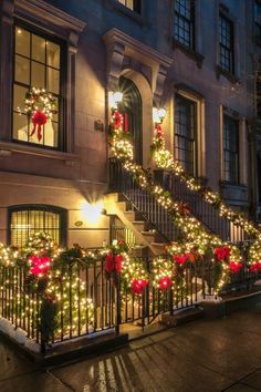 christmas lights decorate the steps and railings of this town house in new york city