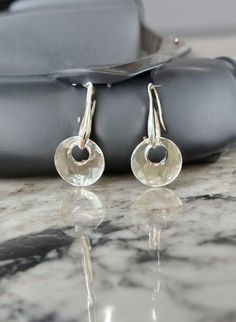 Elevate your everyday style with our stunning 14mm Clear Swarovski "Victory" Earrings, the perfect blend of elegance and simplicity. Handcrafted, these earrings feature 14mm clear Swarovski "Victory" crystals that catch the light beautifully, adding a touch of sparkle to any outfit. Whether you're heading to the office, running errands, or enjoying a night out, these versatile earrings are designed for everyday wear and effortlessly transition from day to night.  Ideal gift for any occasion. Elegant Round Pendant Earrings With Ear Wire, Modern Round Faceted Jewelry, Modern Faceted Round Jewelry, Elegant Silver Round Pendant Earrings, Sterling Silver Round Earrings With Polished Finish, Silver Round Cut Earrings For Everyday, Polished Sterling Silver Round Cut Earrings, Formal Sterling Silver Round Pendant Earrings, Round Earrings With Shiny Finish For Anniversary