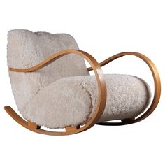 a rocking chair made out of sheepskin and wooden sleighs is shown