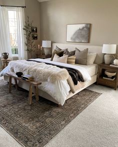 a large bed sitting in a bedroom next to a window