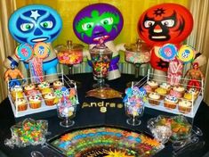 an assortment of candies and cupcakes on a table