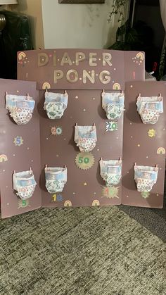 a sign with diapers on it that says diaper pong in front of them