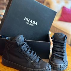 Step Out In Style With These Sleek Black High-Top Sneakers From Prada. Perfect For Any Casual Occasion, These Shoes Offer Both Comfort And Luxury. Black High Top Sneakers, Men's High Top Sneakers, Hightop Sneakers, Shoes Prada, Mens High Tops, Black High Tops, Prada Shoes, High Top