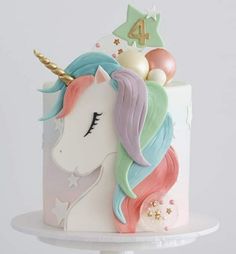 a white cake decorated with an unicorn's head