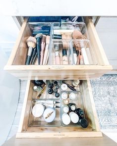 two wooden drawers filled with makeup brushes and other items