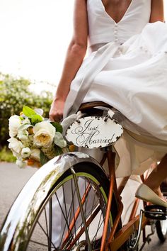 the bride is riding her bike down the street