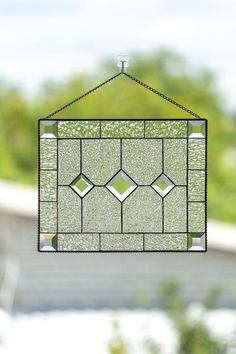 a stained glass window hanging from a chain