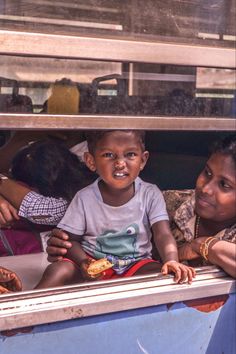 two women and a child are looking out the window