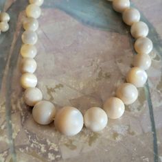 This is a vintage, mother of pearl, graduated bead necklace. There is a knot as a closure, some wear on the beads and a length of thread that doesn't have beads. All sales are final. The necklace is 25.25 inches in length. If you have a wish list or are looking for something specific, please ask. I may have exactly what you are looking for. As always please convo me with any questions or concerns regarding this item or with any international shipping questions. Unfortunately I do not accept returns or grant refunds. All shipping fees include handling fees. If you would like to combine shipping costs for more than one item, I would be happy to do so if you convo me before purchase. Purchasing my item means you have read, understood and will abide by my policies. Sorry, I do not accept trade Vintage Single Strand Beads For Formal Occasions, Vintage Pearl Necklace With Polished Beads For Gifts, Single Strand Mother Of Pearl Beaded Necklaces, Vintage Single Strand Pearl Necklace With Round Beads, Vintage Beaded Shell Necklace With Round Beads, Vintage Adjustable Pearl Necklace With Round Beads, Adjustable Vintage Pearl Necklace With Round Beads, Vintage Beaded Shell Necklace, Vintage Adjustable Beaded Shell Necklace