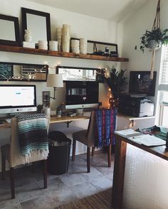 an image of a home office with two computers on the desk and shelves above it