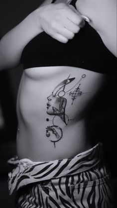 a woman with a tattoo on her stomach