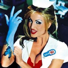 a woman dressed as a nurse with blue hands and tattoos on her chest is posing for the camera