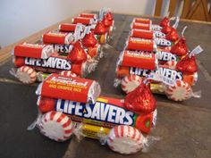 candy bar wrappers with life savers wrapped in red and white foil, on top of a table