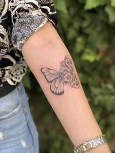 a woman with a butterfly tattoo on her arm