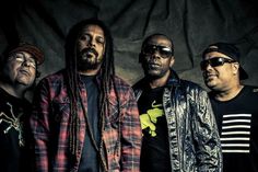 three men standing next to each other with dreadlocks on their heads and wearing sunglasses