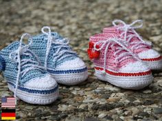 three crocheted shoes sitting on top of a stone floor next to each other