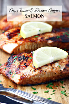 grilled salmon with lemon and parsley on a cutting board