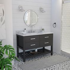 a bathroom with a sink, mirror and shower stall is shown in this image from the front view