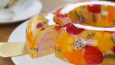 a close up of a cake with fruit on it