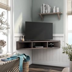 a flat screen tv sitting on top of a wooden shelf in a living room next to a window