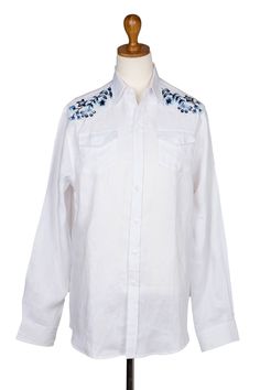 Designed by Made Suciati in Bali, this crisp white shirt is crafted from 100% linen. Accented by hand-embroidered flowers on each shoulder, the button-up shirt features long sleeves, a collared neckline, and two patch pockets on the chest. Traditional White Linen Shirt, Traditional Linen Shirt For Spring, Traditional Fit Embroidered Shirt For Spring, Spring Embroidered Traditional Fit Shirt, Traditional Fit White Shirt For Spring, Spring Embroidered Linen Shirt, White Traditional Fit Shirt For Spring, White Regular Fit Shirt For Spring, Classic Embroidered Summer Shirt