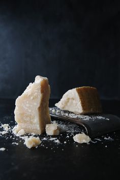 a piece of cake sitting on top of a black counter next to a spatula