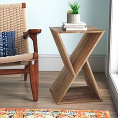 a wooden table sitting next to a chair in a room