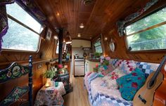 the interior of an rv with wood paneling and lots of decorations on the walls