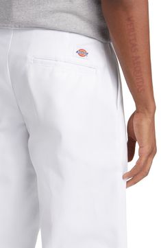 Cut from the brand's signature workwear twill, these wrinkle- and stain-resistant pants feature a relaxed fit and slightly tapered legs for a timeless look. 32" inseam; 18" leg opening; 11" front rise; 14" back rise (size 32) 65% polyester, 35% cotton Machine wash, tumble dry Imported Classic White Straight Leg Work Pants, Classic Relaxed Fit Work Pants With Belt Loops, White Cotton Work Pants, Tapered Bottoms For Workwear, Tapered Cotton Pants, White Straight Pants With Five Pockets, White Workwear Pants With Welt Pockets, White Straight Leg Pants With Patch Pockets, White Dickies