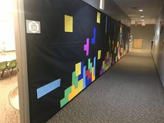 an office hallway decorated with colorful sticky notes