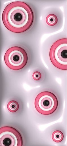 some pink and white circles are in the air with black dots on it's surface