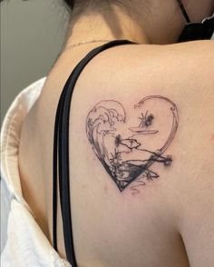 a woman with a heart tattoo on her shoulder