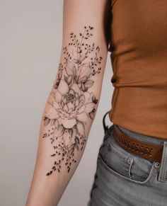 a woman with a flower tattoo on her arm