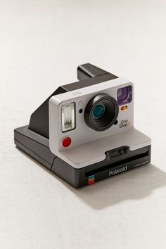 an old polaroid camera sitting on top of a table