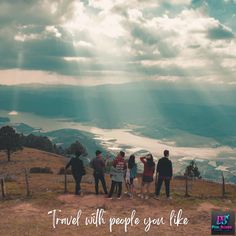 four people standing on top of a hill with the words travel with people you like