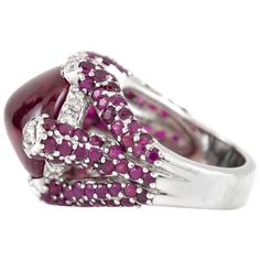 The ring is finely crafted in 18k white gold with robelite as center stone weighing approximately total of 12.00 carat, diamonds on the side weighing approximately total of 0.20 carat and ruby on the side weighing approximately total of 2.00 carat.