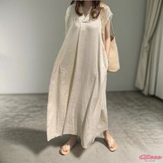 Qteee - Sleeveless Flowy Dress with a Loose and Minimalistic Design Casual Plain Maxi Dress For Beach, Casual Plain Maxi Dress For Summer, Casual Non-stretch Sleeveless Beach Dress, Casual Sleeveless Plain Maxi Dress, Casual Spring Sleeveless Dress In Solid Color, White Non-stretch Casual Midi Dress, Spring Sleeveless Plain Maxi Dress, Casual V-neck Plain Midi Dress, Casual Non-stretch White Midi Dress