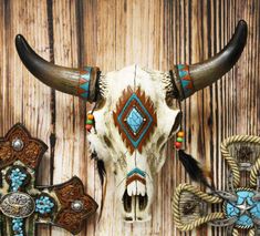 an animal skull with long horns and colorful bead work on it's face