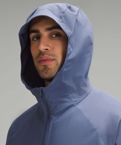 a man wearing a blue jacket and hood