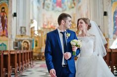 a bride and groom walking down the aisle at their wedding ceremony in an old church