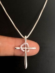 Sterling Silver Cross Heart Rose CZ NecklaceNECKLACE FEATURES:Metal:  All components are made from solid .925 Sterling Silver Model is wearing 16" in length solid .925 Sterling Silver Chain Length available:  16", 18" or 20"Measurement:Height: 27mmWidth: 18mmThickness: 3.5mmStone material: clear cubic zirconiaStone shape: roundTotal number of CZ stones: 12Your Cross Heart CZ Necklace will arrive in a gift box, beautifully wrapped and ready for gifting********************************************* Rose Gold Cross Jewelry For Mother's Day, White Cross Jewelry For Valentine's Day, Sterling Silver Cross Pendant Jewelry For Valentine's Day, Sterling Silver Cross Necklace For Valentine's Day, Silver Cross Pendant Necklaces For Valentine's Day, Silver Cross Pendant Necklace For Valentine's Day, Gift Rose Gold Sterling Silver Cross Necklace, Silver Cross Jewelry With Heart Charm, Pink Sterling Silver Cross Jewelry