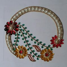 the necklace is decorated with flowers and pearls