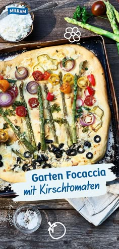 an image of a pizza with asparagus, tomatoes and other toppings on it