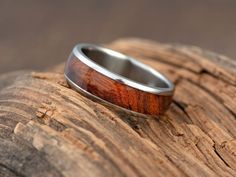 a wooden ring sitting on top of a piece of wood