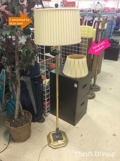 a lamp that is on top of a table in a room with other items around it