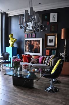 a living room filled with furniture and pictures on the wall