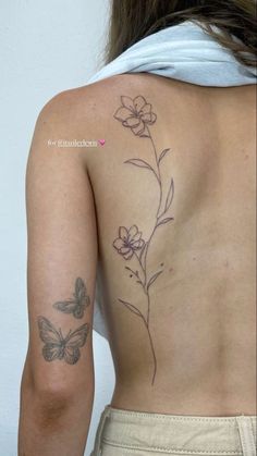 a woman with a butterfly tattoo on her back