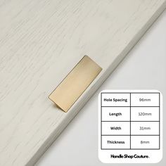 the brass handle is on top of a white wooden surface with measurements for each piece