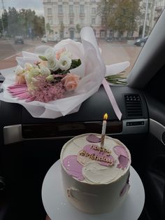 a birthday cake sitting on top of a plate in the back seat of a car